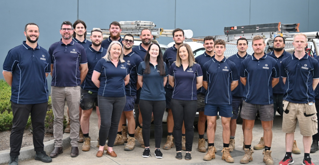team of plumbers outside their offices